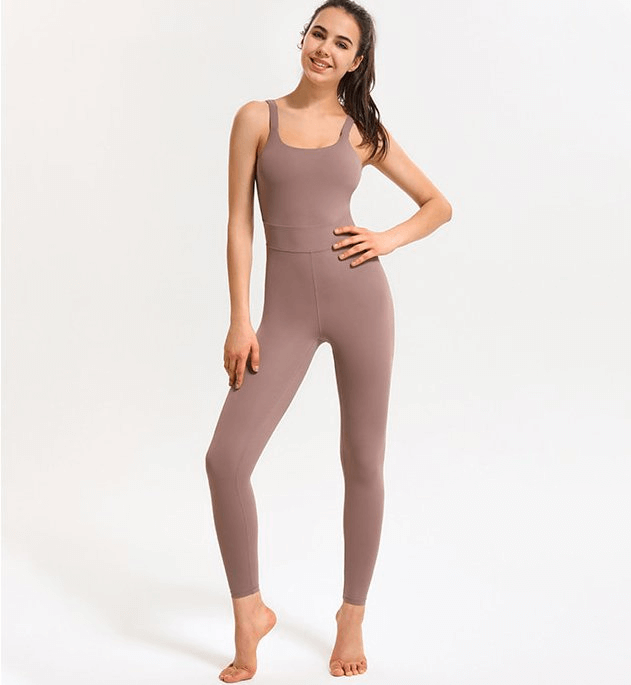 Model wearing a stylish elastic women's open back fitness jumpsuit, perfect for yoga and sports, showcasing a solid design in soft fabric.